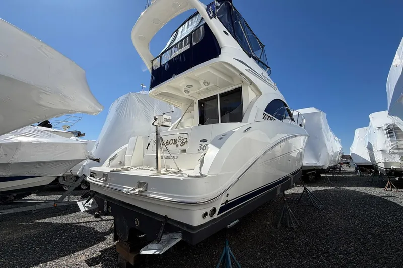 Slide: The Image of 2007 Sea Ray 36 Sedan Bridge yacht on stands, surrounded by covered boats. - 3