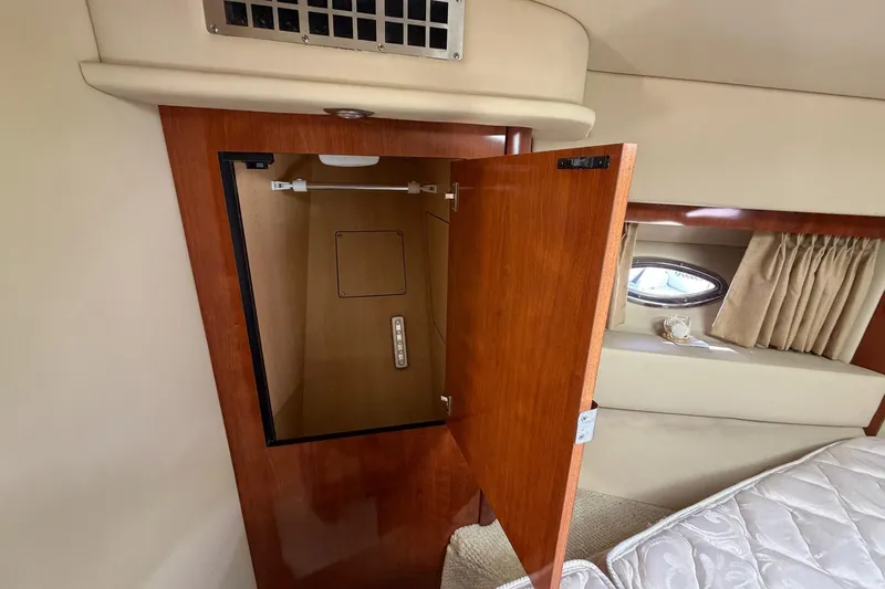 Slide: The Image of 2007 Sea Ray 36 Sedan Bridge interior closet with open wooden door. - 30