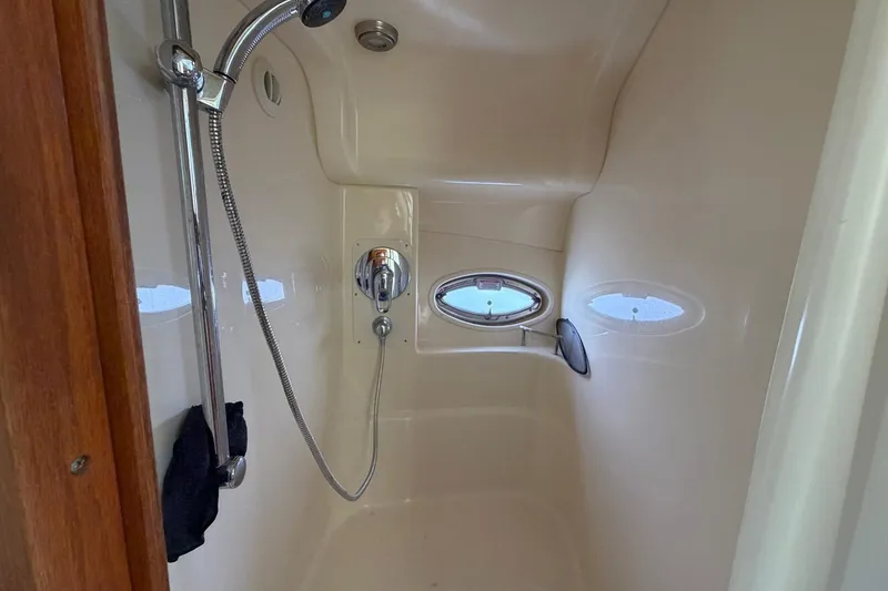 Slide: The Image of Shower area inside 2007 Sea Ray 36 Sedan Bridge yacht with porthole window. - 32