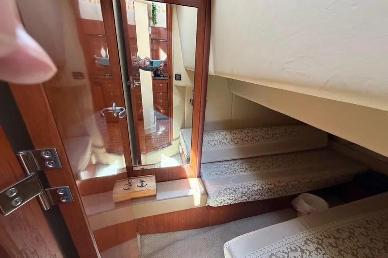 Slide: The Image of Interior cabin of 2007 Sea Ray 36 Sedan Bridge with mirrored door and patterned seating. - 33