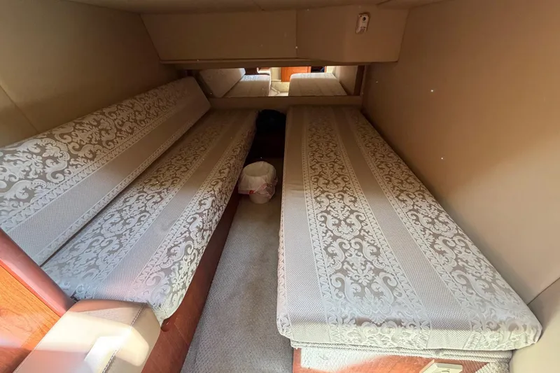 Slide: The Image of 2007 Sea Ray 36 Sedan Bridge cabin with twin beds and patterned bedding. - 37