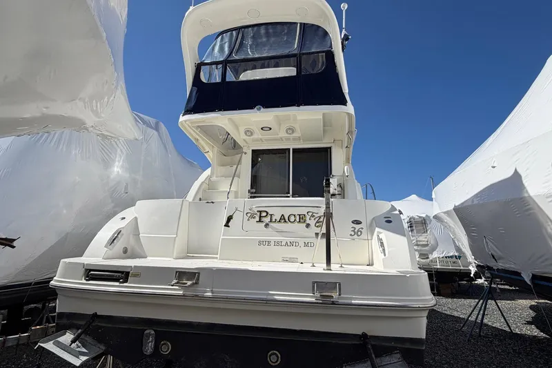 Slide: The Image of 2007 Sea Ray 36 Sedan Bridge yacht docked, rear view under clear blue sky. - 5