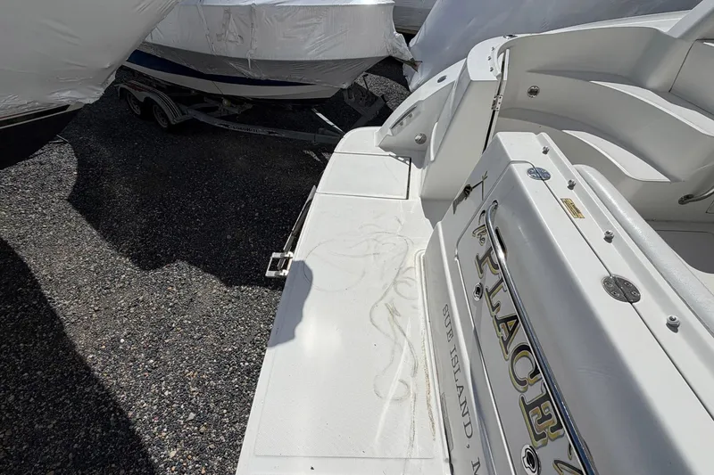 Slide: The Image of 2007 Sea Ray 36 Sedan Bridge boat docked, showing rear deck and seating area. - 7