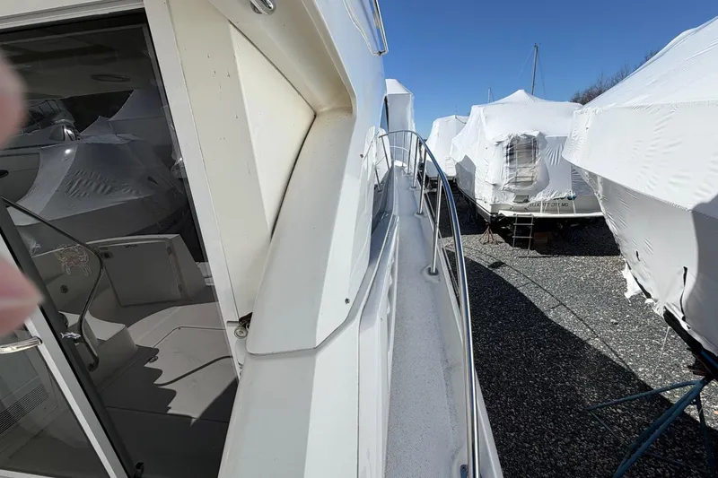 Slide: The Image of 2007 Sea Ray 36 Sedan Bridge yacht docked, surrounded by covered boats. - 9
