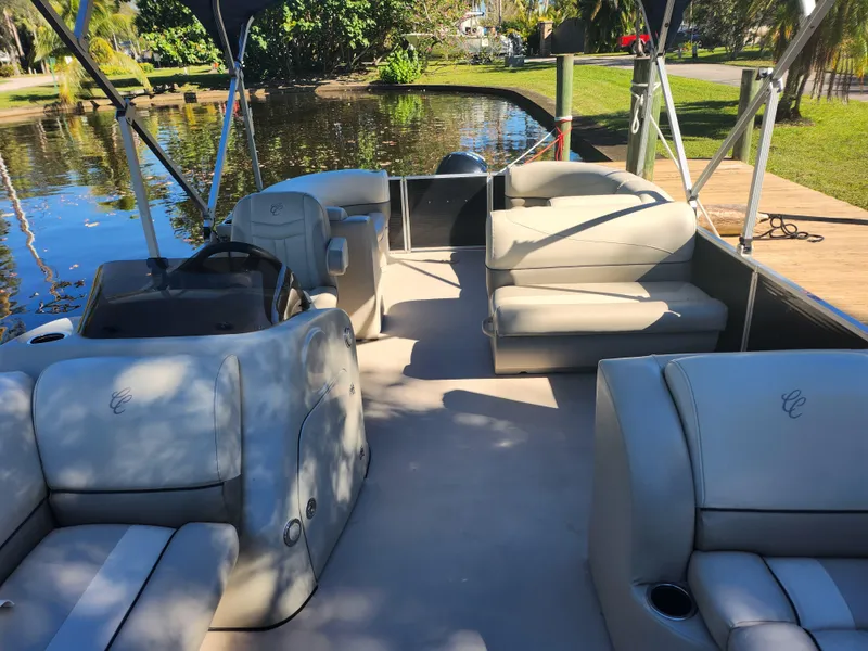 Slide: The Image of Interior of a 2020 Cypress Cay Seabreeze 232 pontoon boat by the water. - 10