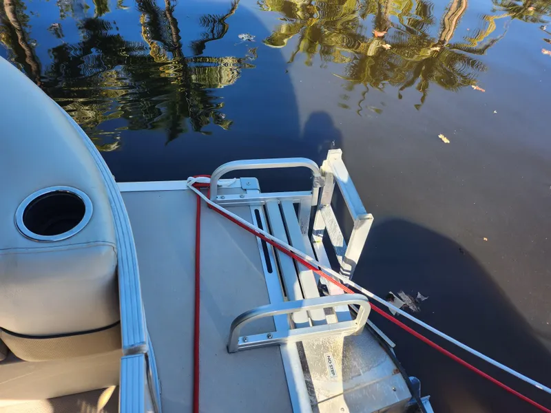 Slide: The Image of Cypress Cay Seabreeze 232 boat docked by water, 2020 model. - 14