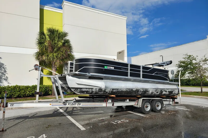 Slide: The Image of 2020 Cypress Cay Seabreeze 232 pontoon boat on trailer in parking lot. - 26