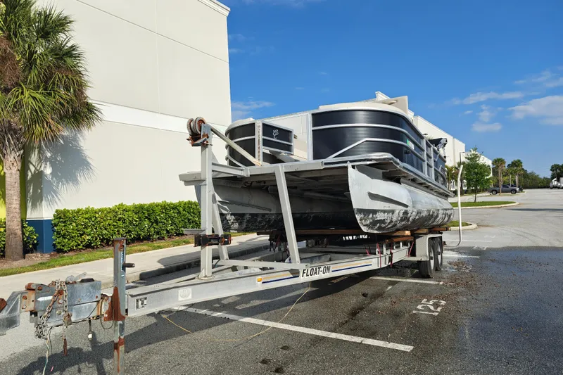 Slide: The Image of 2020 Cypress Cay Seabreeze 232 pontoon boat on trailer in parking lot. - 27