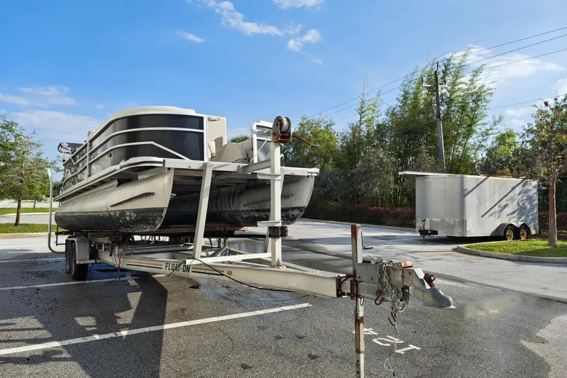Slide: The Image of 2020 Cypress Cay Seabreeze 232 pontoon boat on trailer in parking lot. - 29