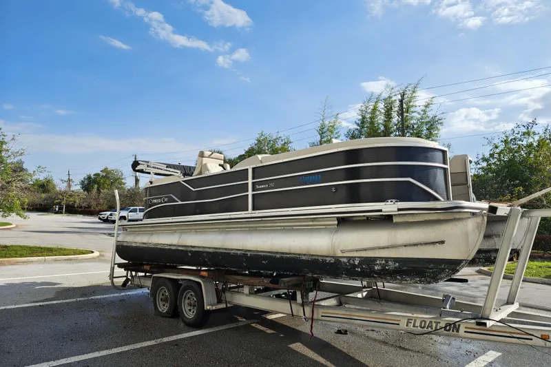 Slide: The Image of 2020 Cypress Cay Seabreeze 232 pontoon boat on trailer in parking lot. - 30