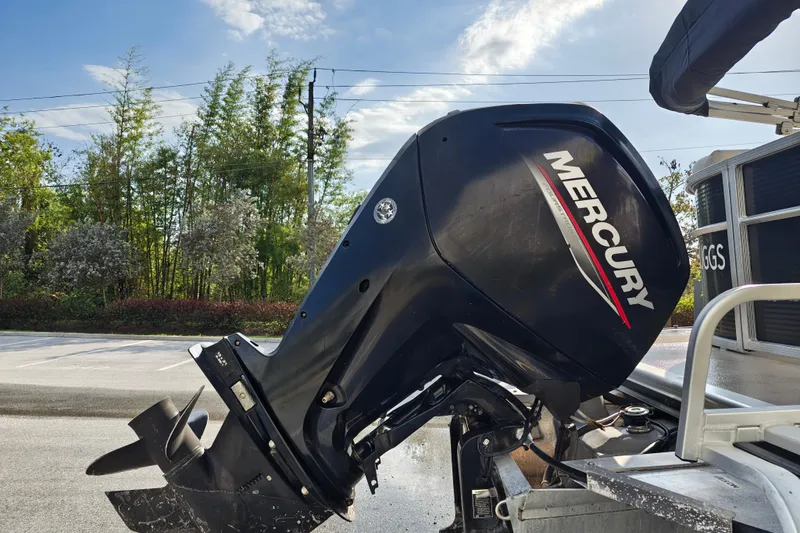 Slide: The Image of 2020 Cypress Cay Seabreeze 232 with Mercury outboard motor, parked outdoors. - 35