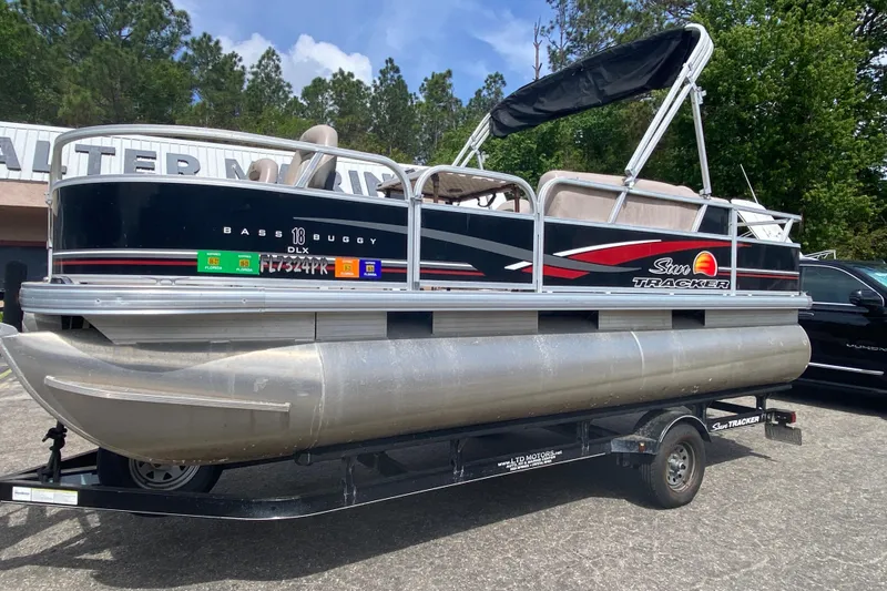 Slide: The Image of 2014 Sun Tracker 18 DLX pontoon boat on trailer, parked outdoors. - 3