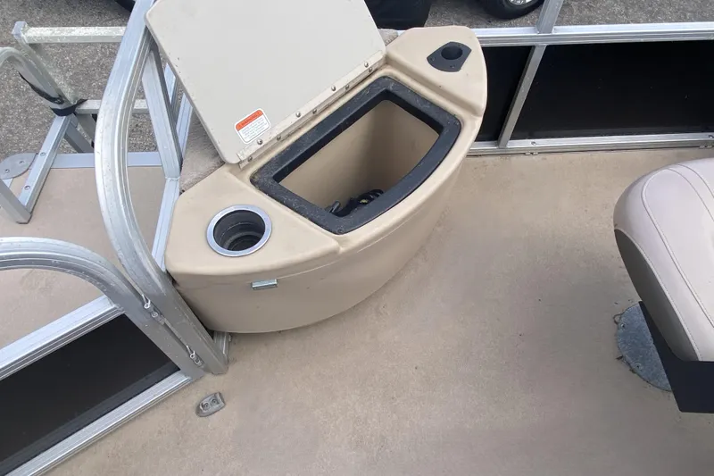 Slide: The Image of 2014 TRACKER MARINE SUN TRACKER 18 DLX boat interior with storage compartment and cup holder. - 6