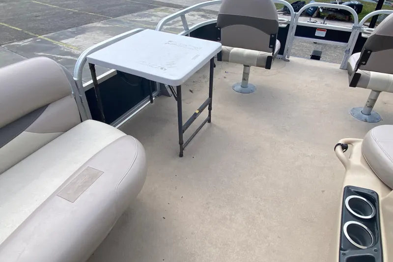 Slide: The Image of 2014 TRACKER MARINE SUN TRACKER 18 DLX pontoon boat interior with seating and table. - 8