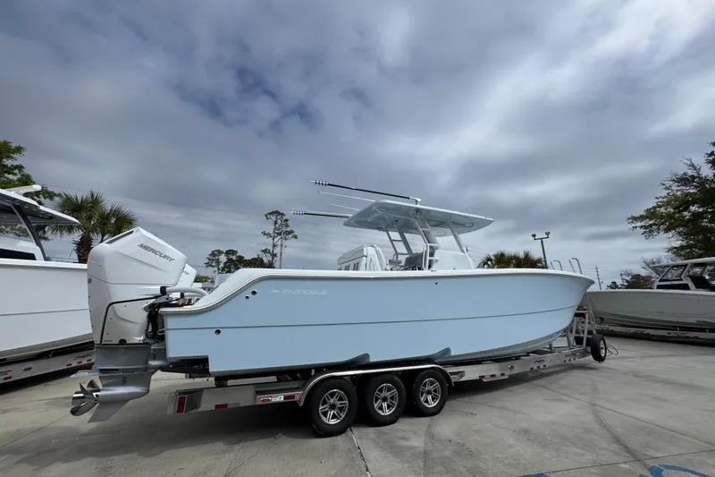 Slide: The Image of 2026 Invincible 33 Catamaran on trailer, featuring twin Mercury outboard engines. - 11