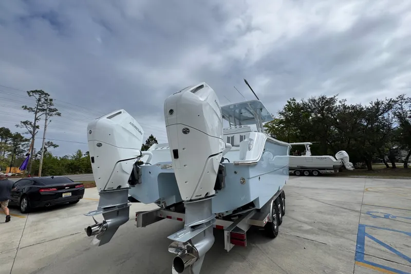 Slide: The Image of 2026 Invincible 33 Catamaran with dual outboard engines on a trailer. - 13