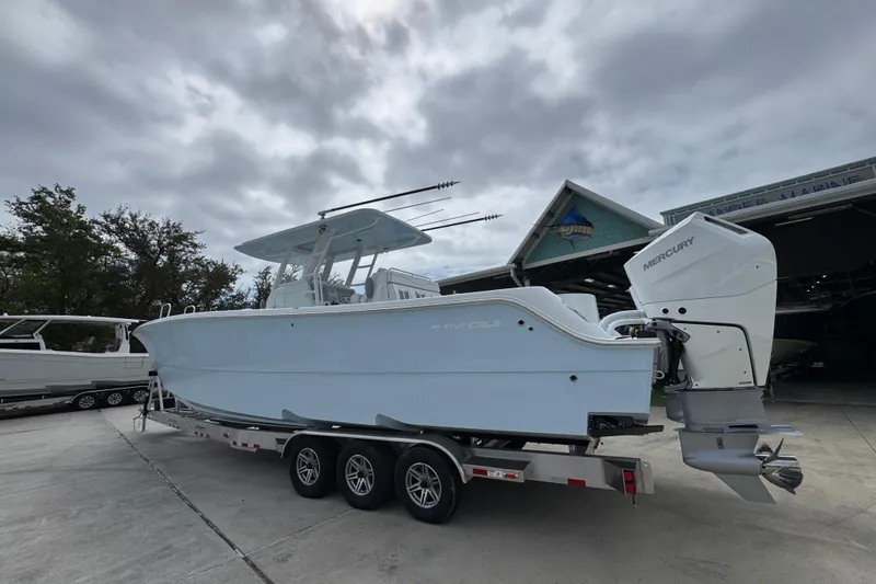 Slide: The Image of 2026 Invincible 33 Catamaran on trailer, featuring dual Mercury outboard engines. - 16