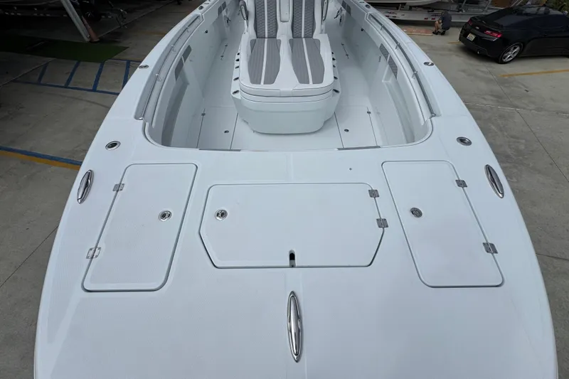 Slide: The Image of 2026 Invincible 33 Catamaran boat deck with seating and storage compartments. - 17