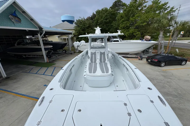 Slide: The Image of 2026 Invincible 33 Catamaran docked at a marina, showcasing sleek design and spacious deck. - 18