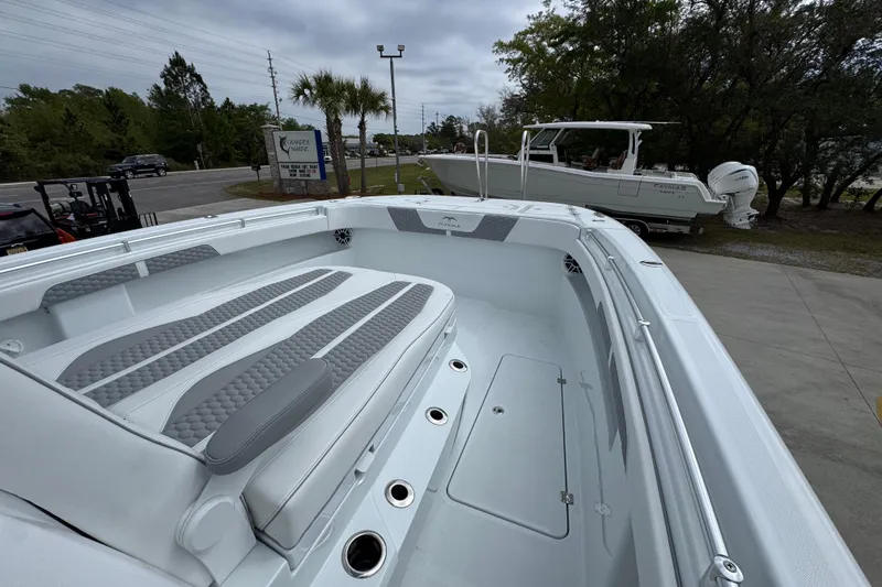 Slide: The Image of 2026 Invincible 33 Catamaran with sleek seating and modern design in a marina setting. - 20