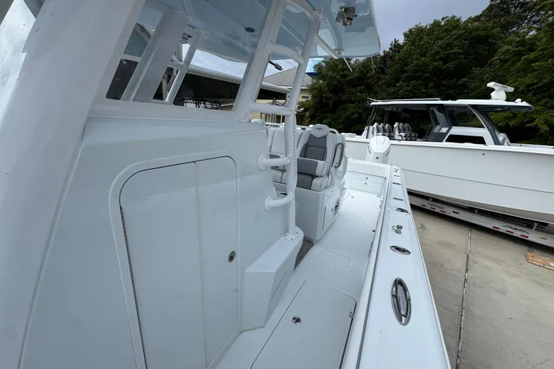Slide: The Image of 2026 Invincible 33 Catamaran with sleek design, spacious deck, and modern seating. - 23