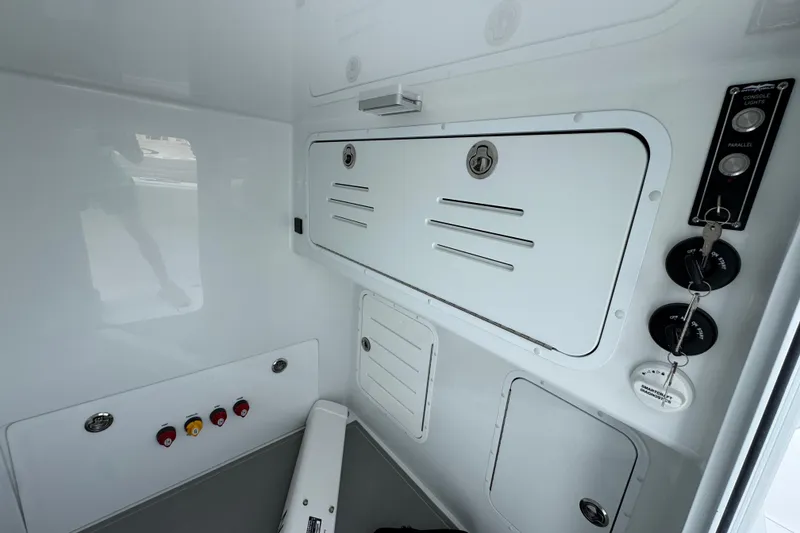 Slide: The Image of Interior view of 2026 Invincible 33 Catamaran with control panel and storage compartments. - 26