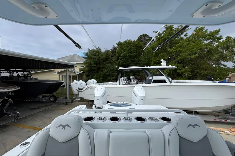 Slide: The Image of 2026 Invincible 33 Catamaran in marina, showcasing sleek design and powerful engines. - 29