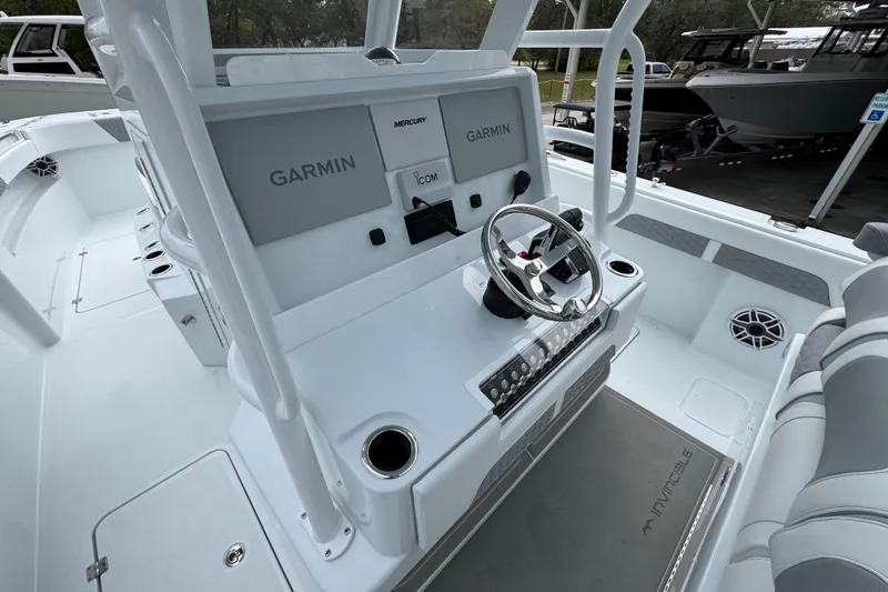 Slide: The Image of 2026 Invincible 33 Catamaran cockpit with Garmin navigation and Mercury controls. - 31