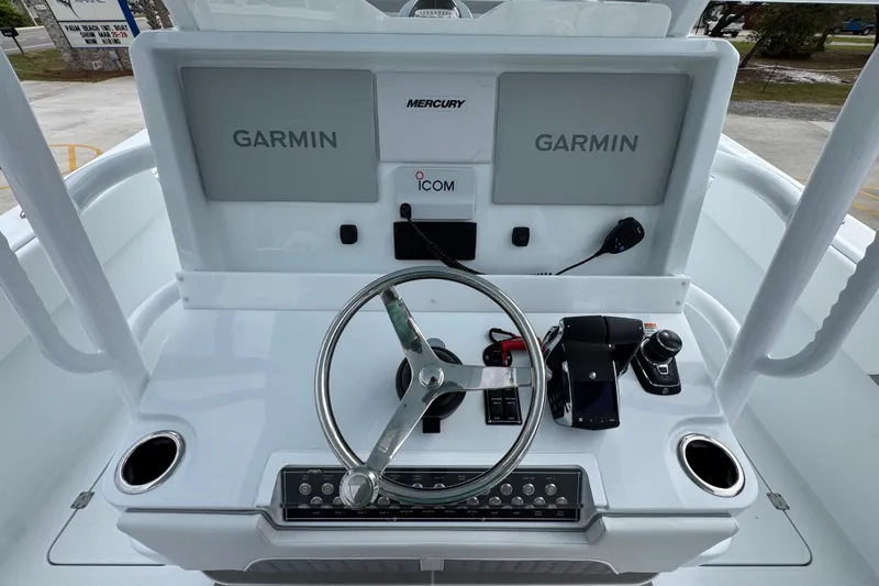Slide: The Image of Helm of 2026 Invincible 33 Catamaran with Garmin displays and Mercury controls. - 32