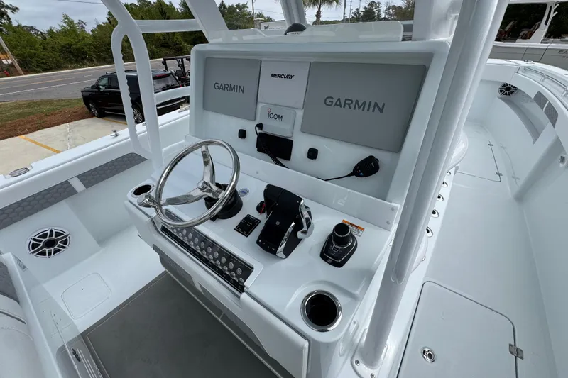 Slide: The Image of Helm of 2026 Invincible 33 Catamaran featuring Garmin displays and Mercury controls. - 33