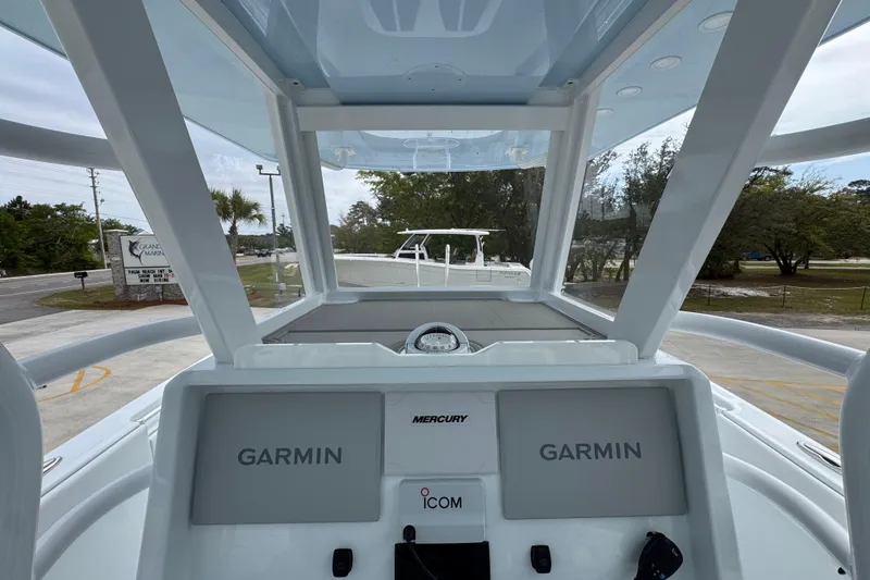 Slide: The Image of 2026 Invincible 33 Catamaran dashboard with Garmin displays and Mercury controls. - 34