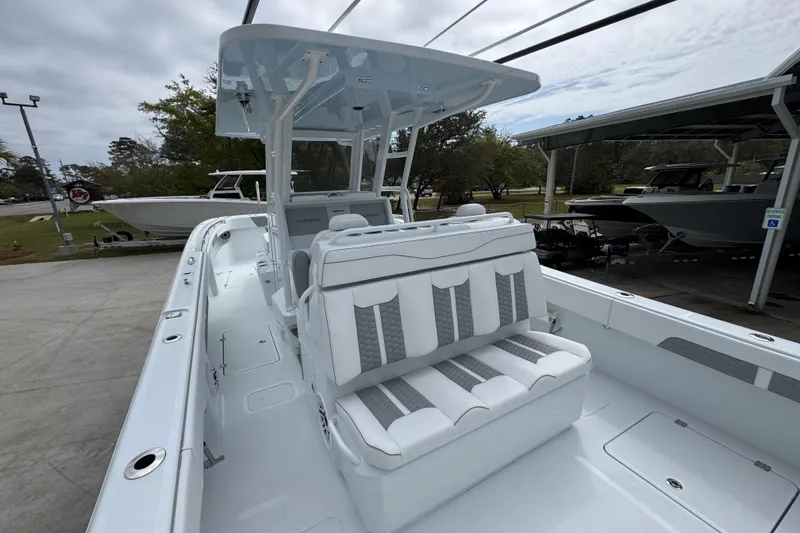 Slide: The Image of 2026 Invincible 33 Catamaran with sleek seating and modern design in a marina setting. - 35