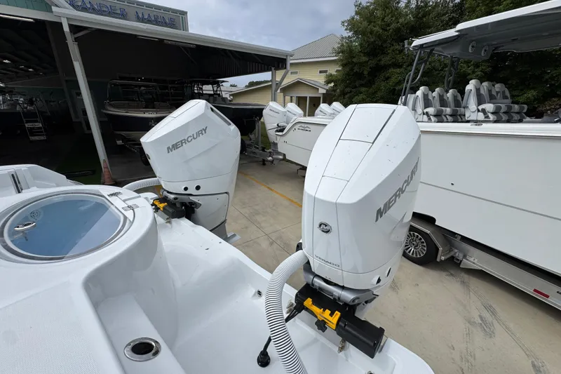 Slide: The Image of 2026 Invincible 33 Catamaran with dual Mercury outboard engines at a marina. - 41