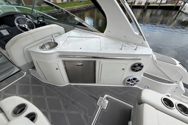 Slide: The Image of Luxury interior of 2022 Regal 33 XO boat with kitchenette and seating area. - 10