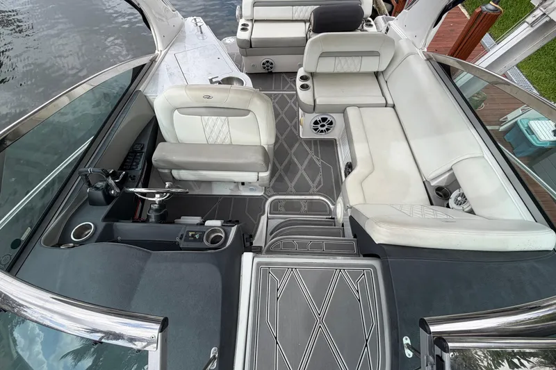 Slide: The Image of 2022 Regal 33 XO boat interior with luxurious seating and modern helm design. - 12