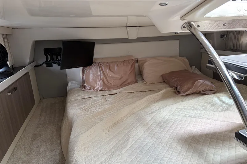 Slide: The Image of Cozy cabin interior of 2022 Regal 33 XO yacht with bed and TV. - 13