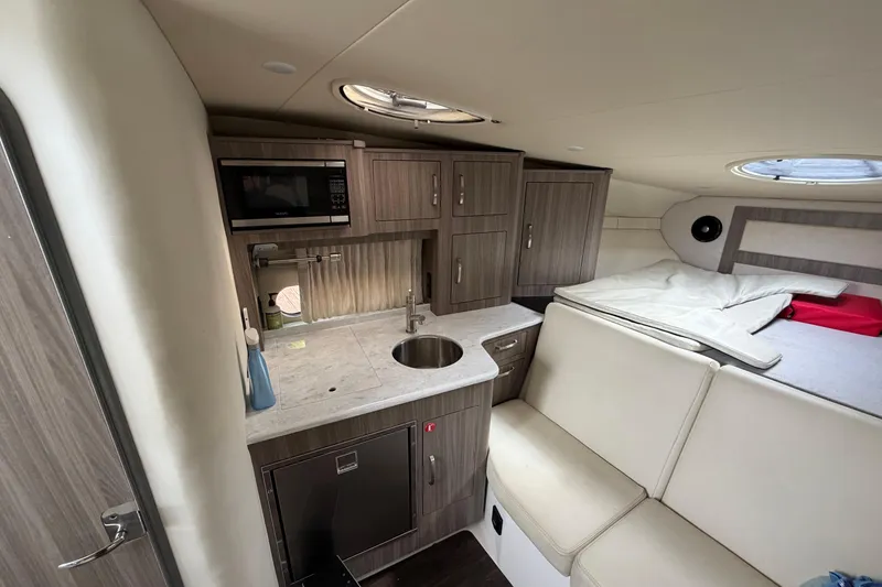 Slide: The Image of Interior of 2022 Regal 33 XO yacht with kitchenette and sleeping area. - 16