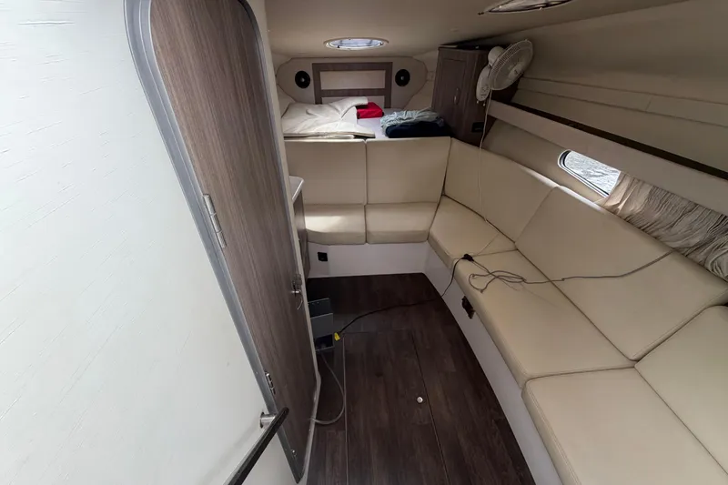 Slide: The Image of Interior of 2022 Regal 33 XO boat with beige seating and wood accents. - 21