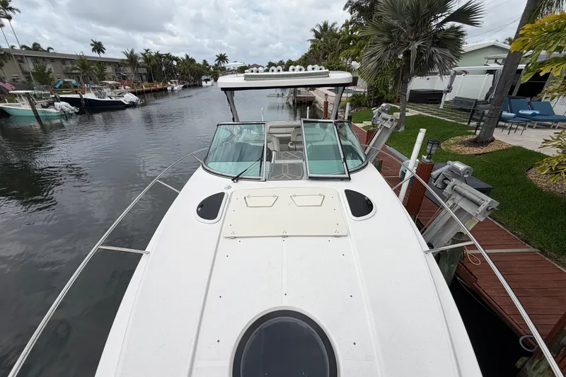 Slide: The Image of 2022 Regal 33 XO boat docked in a scenic canal setting. - 4