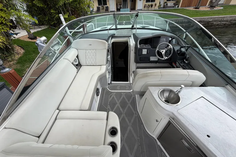 Slide: The Image of 2022 Regal 33 XO boat interior with seating, helm, and kitchenette. - 9