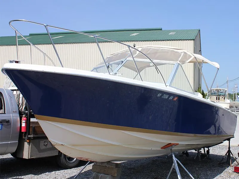 The Image of 1970 Bertram 25 Moppie boat on trailer, painted blue and white. - 1