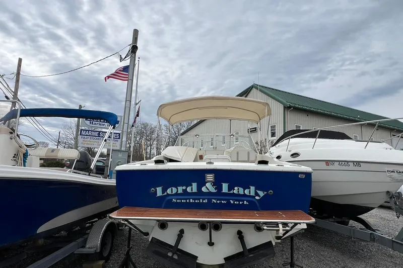 Slide: The Image of 1970 Bertram 25 Moppie boat named "Lord & Lady" in a marina setting. - 13