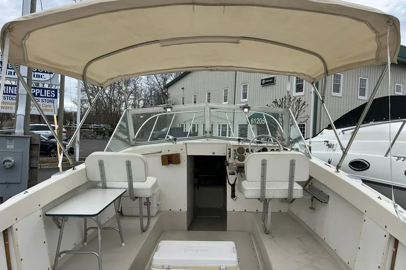 Slide: The Image of 1970 Bertram 25 Moppie boat interior with canopy, seating, and steering wheel. - 18