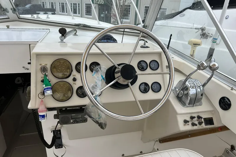 Slide: The Image of 1970 Bertram 25 Moppie boat dashboard with steering wheel and instrument panel. - 20