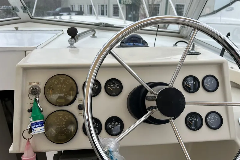Slide: The Image of 1970 Bertram 25 Moppie boat dashboard with steering wheel and gauges. - 23