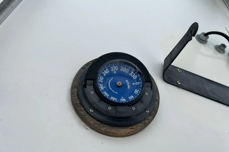 Slide: The Image of Compass on 1970 Bertram 25 Moppie boat dashboard, showing navigation directions. - 25