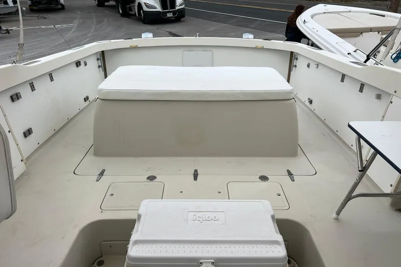 Slide: The Image of 1970 Bertram 25 Moppie boat interior with seating and cooler on deck. - 28