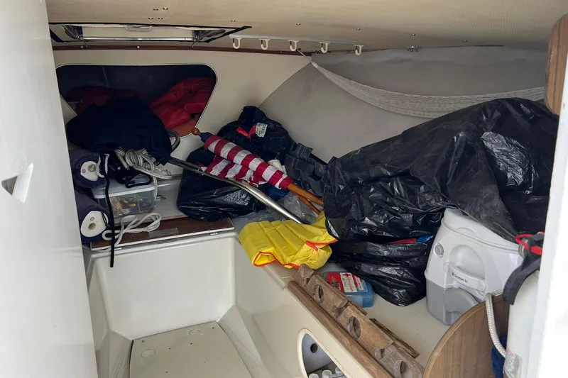 Slide: The Image of Interior of a 1970 Bertram 25 Moppie boat with stored equipment and supplies. - 29