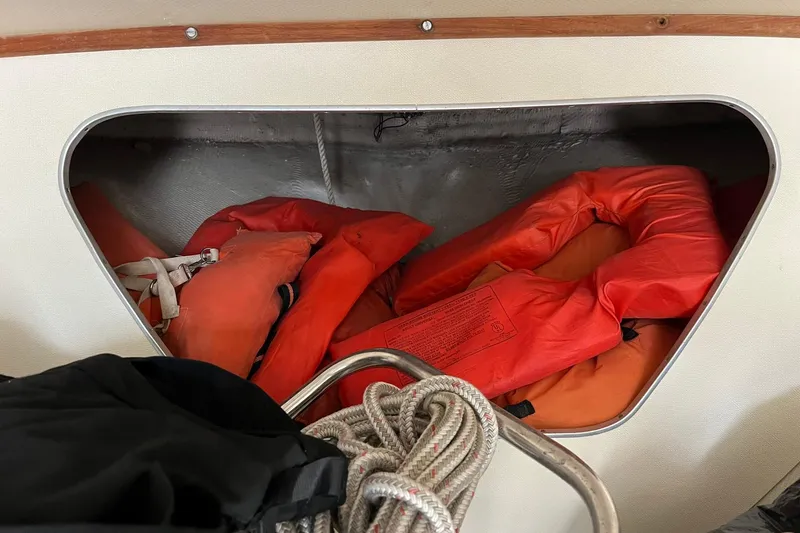 Slide: The Image of Storage compartment on a 1970 Bertram 25 Moppie with life jackets and rope. - 31