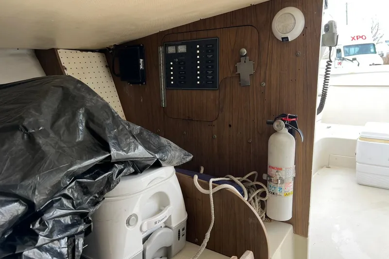 Slide: The Image of 1970 Bertram 25 Moppie interior with control panel, fire extinguisher, and storage area. - 34